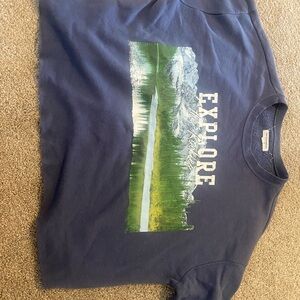Blue “Explore the Rockies” sweatshirt with a nature scene on the front